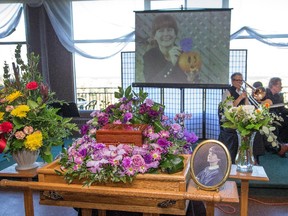 Musicians perform while a images on screen played beside them during Thursday's celebration of life for Nathalie Warmerdam.