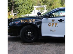 OPP officer guards scene as police tape surrounds a home where police say one person was shot to death at 37 Szczipior Rd. in Wilno (Ontario), Tuesday, September 22, 2015. Police arrested a person of interest mid-afternoon. Mike Carroccetto / Ottawa Citizen