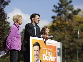 Ottawa Centre NDP candidate Paul Dewar, standing beside a green stake that marks where an elm was cut down, is joined by former Somerset Ward Coun. Diane Holmes and Tree Ottawa's Velta Tomsons as he discusses a plan to protect urban trees.