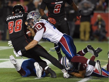 Ottawa Redblacks' Brad Sinopoli is stopped by Montreal Alouettes' Marc-Olivier Brouillette (10) during first half CFL action.