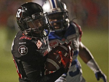 Ottawa Redblacks' Chris Williams 80, makes a TD catch against Montreal Alouettes' Jerald Brown, 39, during the first half.