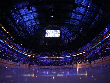 Fans of the Buffalo Sabres hold glow sticks during pregame ceremonies.