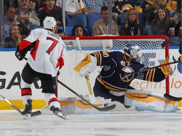 Kyle Turris #7 of the Ottawa Senators scores a goal in the first minute of play of the first period against Robin Lehner #40 of the Buffalo Sabres.