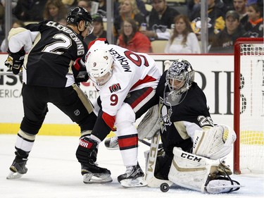 Marc-Andre Fleury #29 of the Pittsburgh Penguins makes a save behind Milan Michalek #9 of the Ottawa Senators.