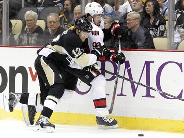 Ben Lovejoy #12 of the Pittsburgh Penguins checks Mika Zibanejad #93 of the Ottawa Senators.