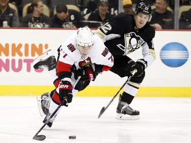 Kyle Turris #7 of the Ottawa Senators handles the puck in front of Ben Lovejoy #12 of the Pittsburgh Penguins.