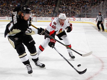 Daniel Sprong #41 of the Pittsburgh Penguins battles for the loose puck against Patrick Wiercioch #46 of the Ottawa Senators.