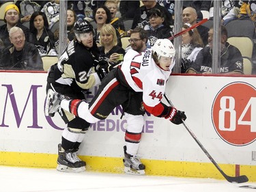 Bobby Farnham #24 of the Pittsburgh Penguins finishes his check on Jean-Gabriel Pageau #44 of the Ottawa Senators.