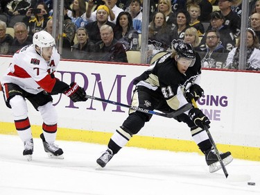 Daniel Sprong #41 of the Pittsburgh Penguins handles the puck in front of Kyle Turris #7 of the Ottawa Senators.