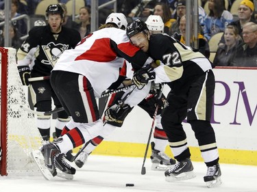 Patric Hornqvist #72 of the Pittsburgh Penguins battles for the puck against Marc Methot #3 of the Ottawa Senators.