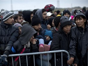 People wait in lines to enter a registration centre for migrants and refugees in Opatovac, Croatia on Tuesday.