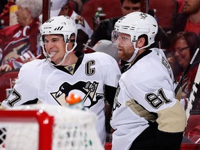 Phil Kessel celebrates with captain Sidney Crosby after scoring his first goal as a Penguin last weekend against Arizona.