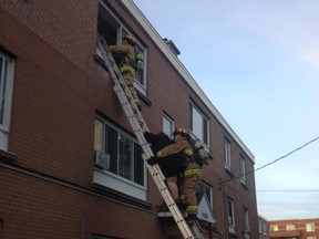 Firefighters rescue residents at 1899 Carling Ave. Friday.