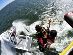 Sergeant Terrence Grandy (left) and Master Corporal Chris Martin (right) both Search and Rescue Technicians, are being hoisted up into a CH-149 Cormorant helicopter from a boat over the Northumberland Strait off of Prince Edward Island during a boat camp exercise on June 15, 2015.

Photo: Master Corporal Johanie Maheu, 14 Wing Imaging – Greenwood, NS
GD2015-0334-11
~
Le sergent Terrence Grandy (à gauche) et le caporal chef Chris Martin (à droite), tous les deux techniciens en recherche et sauvetage, sont hissés à bord d’un hélicoptère CH-149 Cormorant depuis un bateau dans le détroit de Northumberland au large de l’Île du Prince Édouard, lors d’un exercice de navigation, le 15 juin 2015. 

Photo : Caporal chef Johanie Maheu, Service d’imagerie de la 14e Escadre – Greenwood (N. É.)
GD2015-0334-11