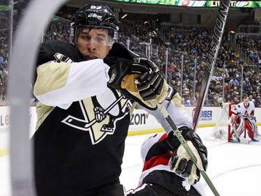 Pittsburgh Penguins' Sidney Crosby, left, collides with Ottawa Senators' Mika Zibanejad during the second period.