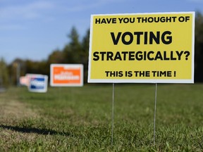 Sign that encourages voters to vote strategically is set up on Campeau drive in Kanata on Monday.