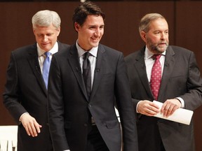 Liberal Leader Justin Trudeau, centre, is flanked by Conservative Leader Stephen Harper and NDP Leader Tom Mulcair after the Munk Debate on Canada's foreign policy in Toronto in September.
