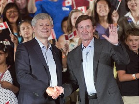 Conservative Leader Stephen Harper shakes hands with Wayne Gretzky during a campaign event in Toronto on Friday, Sept. 18, 2015.