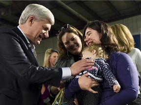 Conservative Leader Stephen Harper talks with moms and their children after speaking during a campaign stop in Saskatoon, Sask, on Wednesday, October 7, 2015.