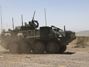 FORT IRWIN, Calif.- U.S. Army Soldiers from 4th Battalion, 23rd Infantry Regiment, 2nd Stryker Brigade Combat Team, 2nd Infantry Division, maneuver through the training area during Decisive Action Rotation 14-08 at the National Training Center here, June 17, 2014.  Decisive Action Rotations allow units to fully exercise their mission essential task list that supports the Army's core competencies: wide area security and combined arms maneuver. (U.S. Army photo by Spc. Randis Monroe, Operations Group, National Training Center)