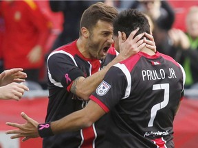 The Ottawa Fury FC's Sinisa Ubiparipovic, left, celebrates with teammate Paulo Junior after scoring the first goal during their North American Soccer League game against Edmonton FC at TD Place in Ottawa on Sunday, Oct. 4, 2015.