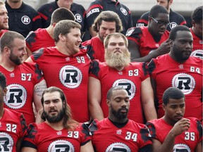 The Ottawa Redblacks' Jon Gott, 63, squeezes in for the team photo at TD Place on Monday, Oct. 5, 2015.