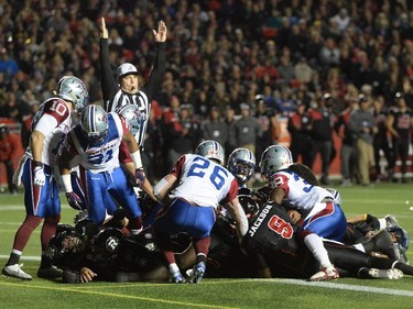 The ref signals a touchdown as Ottawa Redblacks cross the line during first half CFL action.