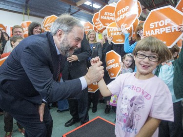 NDP Leader Tom Mulcair greets a young supporter at a rally, Monday in Maple Ridge, B.C.