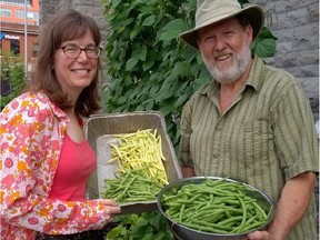 Volunteers Diana Mahaffy and Brian Ure display some of the beans produced by the repurposed planters.