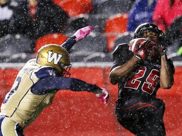 William Powell of the Ottawa Redblacks catches the touchdown as he is taken down by Graig Newman of the Winnipeg Blue Bombers during first half CFL action.