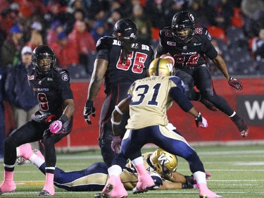 William Powell of the Ottawa Redblacks jumps over the Winnipeg Blue Bombers during first half CFL action.