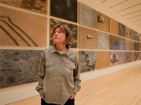 Sophie Ristelhueber, with her installation, Fait,  at the National Gallery of Art in Ottawa, on Nov. 5, 2016. (Wayne Cuddington/ Ottawa Citizen)
