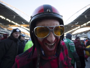 A football fan smiles for a photo as he attends the 103rd Grey Cup between the Edmonton Eskimos and the Ottawa Redblacks in Winnipeg, Man., on Sunday, Nov. 29, 2015.