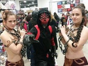A pair of princess Leias flank a fellow cosplayer at the 2015 Pop Expo on Saturday.