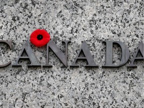 A poppy is left on the word Canada late in the afternoon that the annual Remembrance Day Ceremony took place at the National War Memorial in Ottawa. Assignment - 118932 Photo taken at 15:20 on November 11.