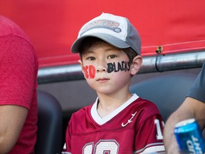 A young Redblacks fan in the stands as the Ottawa Redblacks take on the Calgary Stampeders in CFL action at TD Place in Ottawa.