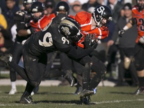 The Ottawa Sooners' Joey McDonald is wrapped up by Windsor's Adam Slikboer during the Ontario Football Conference championship game on Sunday, Nov. 1, 2015.