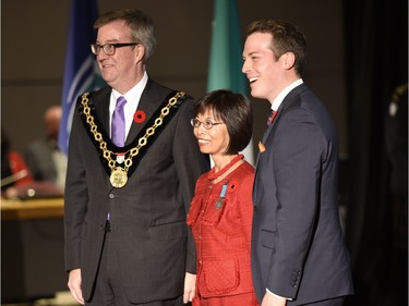 Alicia S. Natividad receives the Order of Ottawa from Mayor Jim Watson and Councillor Mathieu Fleury at City Hall in Ottawa on Tuesday, November 10, 2015.