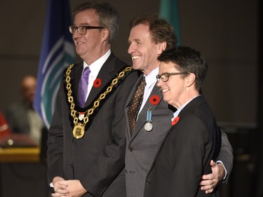 Allan Rock receives the Order of Ottawa from Mayor Jim Watson and Councillor Catherine McKenny at City Hall in Ottawa on Tuesday, November 10, 2015.
