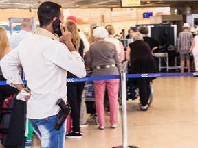 An armed security worker talks on his phone in front of the luggage screening section at the airport of Sharm el-Sheikh, Egypt, Saturday, Nov. 7, 2015.  In an abrupt turnaround, Russia on Friday suspended all passenger flights to Egypt after days of resisting U.S. and British suggestions that a bomb may have brought down a Russian plane in the Sinai Peninsula a week ago.