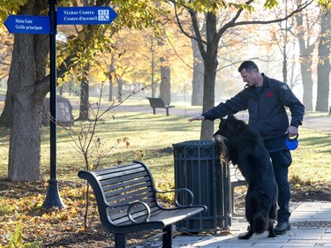 An RCMP officer and his police dog sweep the grounds of of Rideau Hall before the swearing-in ceremony of Prime Minister-designate Justin Trudeau in Ottawa on Wednesday, Nov. 4, 2015.