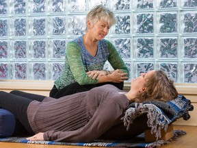 Anne Pitman works with patient Julie Truelove at the Ottawa Integrative Cancer Centre using yoga therapy.