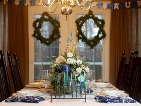 Although the home is a mix of holidays, the dining room leans more toward Hanukkah, with Stars of David fashioned from garland and multiple menorahs.