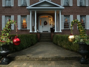 Three-foot-tall ‘grinch trees’ greet visitors to this rural Georgian-inspired home.