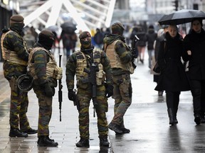 Soldiers patrol a pedestrian shopping street in Brussels on November 21, 2015. All metro train stations in Brussels will be closed on November 21, the city's public transport network said after Belgium raised the capital's terror alert to the highest level, warning of an "imminent threat". As Europe tightens security a week on from the jihadist attacks in Paris that left 130 people dead, Belgium's OCAM national crisis centre raised its alert level to 4 early on November 21, "signifying a very serious threat for the Brussels region".