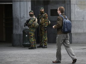 Soldiers stand outside the entrance of Brussels Central Station on November 22, 2015. The Belgian capital was locked down for a second day on November 22 with police and troops on the streets as the authorities hunted for several suspects linked to the Paris attacks. Belgian officials were due to meet later to decide whether to extend the security alert in Brussels, imposed over fears jihadists were plotting similar strikes to the attacks in Paris which left 130 people dead on November 13.