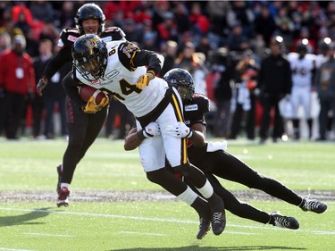 Brandyn Thompson of the Ottawa Redblacks tackle Bakari Grant the Hamilton Tiger-Cats during first half of the East Conference finals at TD Place in Ottawa, November 22, 2015. (Jean Levac/ Ottawa Citizen)