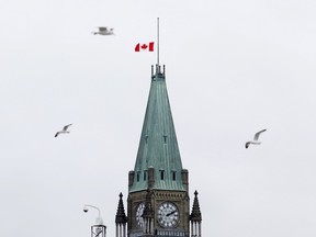 The Canadian flag flies at half-mast over the Parliament Buildings on November 14, 2015 in Ottawa, one day after the terrorist attacks in Paris.