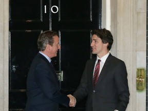 Canadian Prime Minister Justin Trudeau, right, is greeted by British Prime Minister David Cameron outside 10 Downing Street in London, Wednesday Nov. 25, 2015.