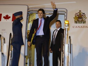 Canadian Prime Minister Justin Trudeau waves as he disembarks from his plane as he arrives for the Asia-Pacific Economic Cooperation (APEC) summit in Manila, Philippines, Tuesday, Nov. 17, 2015. Leaders from 21 countries and self-governing territories are gathering in Manila for the Asia-Pacific Economic Cooperation summit. The meeting's official agenda is focused on trade, business and economic issues but terrorism, South China Sea disputes and climate change are also set to be in focus.